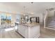 Open concept kitchen with granite island, stainless dishwasher, and view to the dining and living spaces at 867 Ireland Dr., Longs, SC 29568