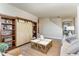 Cozy living room featuring stylish barn door shelving, neutral colors, and a textured rug at 867 Ireland Dr., Longs, SC 29568