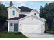 Charming two-story home featuring white siding, a two-car garage, and a well-manicured lawn at 871 Cypress Preserve Circle, Longs, SC 29568