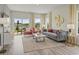 Comfortable living room with lake views, stylish furniture, and ample natural light at 871 Cypress Preserve Circle, Longs, SC 29568