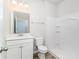 Bathroom boasts white vanity, modern mirror, and shower-tub combo for a clean and functional design at 885 Ireland Dr., Longs, SC 29568