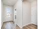 Inviting entryway with wood-look floors and a glass-paneled front door at 885 Ireland Dr., Longs, SC 29568