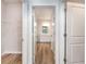 Hallway view showcasing a bathroom with double sinks and an open closet with wire shelving at 885 Ireland Dr., Longs, SC 29568