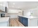 Bright kitchen boasts stainless steel appliances, white cabinets, a large island, and modern countertops at 885 Ireland Dr., Longs, SC 29568