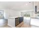 A modern kitchen featuring an island, stainless steel dishwasher, and an open view to the living area at 885 Ireland Dr., Longs, SC 29568