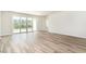 Bright living room with wood-look floors and sliding glass doors to the backyard at 885 Ireland Dr., Longs, SC 29568