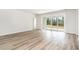 Spacious living room featuring wood-look flooring and sliding glass doors leading to the backyard at 885 Ireland Dr., Longs, SC 29568