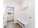 Mudroom with convenient storage bench, cubbies, hooks and a door to the outside at 885 Ireland Dr., Longs, SC 29568