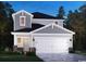 Charming two-story home with gray siding, stone accents, a two-car garage and beautifully landscaped yard at 886 Cypress Preserve Circle, Longs, SC 29568