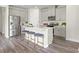 Modern kitchen with stainless steel appliances, center island, and bar stool seating with quartz countertops at 886 Cypress Preserve Circle, Longs, SC 29568