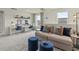 Cozy upstairs loft area with a sofa, ottomans, and a desk area for studying with carpeting at 886 Cypress Preserve Circle, Longs, SC 29568
