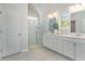 This bathroom boasts a double sink vanity, white cabinets, and a glass enclosed shower at 890 Ireland Dr., Longs, SC 29568