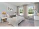 A cozy bedroom showcases natural light, white furniture, and a hanging chair at 890 Ireland Dr., Longs, SC 29568