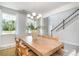 Light-filled dining room with table for six and chandelier next to staircase at 890 Ireland Dr., Longs, SC 29568
