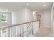 Upstairs hallway featuring wood railings and a view into another room at 890 Ireland Dr., Longs, SC 29568