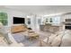 Bright living room featuring a modern open layout, stylish furniture, and hardwood floors at 890 Ireland Dr., Longs, SC 29568