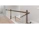 Elegant staircase with wooden handrail and white spindles offering a view to the lower level at 890 Ireland Dr., Longs, SC 29568