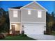 Two-story home showcasing a modern design, a two-car garage, and meticulous landscaping at 895 Cypress Preserve Circle, Longs, SC 29568