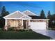 Charming single-story home featuring stone accents, a two-car garage, and a manicured lawn at 908 Cypress Preserve Circle, Longs, SC 29568