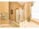 Bright bathroom with a tub, a separate glass shower and a window with an ornamental statue at 912 Berwick Ln., Myrtle Beach, SC 29579