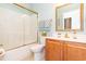 Bright bathroom featuring a shower-tub combination with glass doors and a vanity with a framed mirror at 912 Berwick Ln., Myrtle Beach, SC 29579