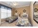 Cozy bedroom with two twin beds, a ceiling fan, neutral walls, and matching bedding and decor at 912 Berwick Ln., Myrtle Beach, SC 29579