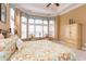 Bright bedroom with a floral comforter, large window, and sitting area at 912 Berwick Ln., Myrtle Beach, SC 29579
