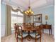 Cozy dining room featuring a round table, decorative chandelier, and large window at 912 Berwick Ln., Myrtle Beach, SC 29579