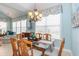 Elegant dining room with a glass-topped table, wicker chairs, and large windows for natural light at 912 Berwick Ln., Myrtle Beach, SC 29579