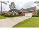 Charming brick home featuring a well-manicured lawn, a two-car garage, and beautiful landscaping at 912 Berwick Ln., Myrtle Beach, SC 29579