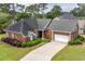 Charming brick home featuring manicured landscaping, a two-car garage, and a paved driveway at 912 Berwick Ln., Myrtle Beach, SC 29579