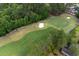 Aerial view of lush golf course with mature trees, sand traps, and well-maintained green at 912 Berwick Ln., Myrtle Beach, SC 29579