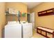 Functional laundry room featuring a washer, dryer, shelving, storage baskets, and bench seating at 912 Berwick Ln., Myrtle Beach, SC 29579