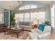 Sun-filled living room featuring a comfortable sofa, patterned armchair, and glass coffee table at 912 Berwick Ln., Myrtle Beach, SC 29579