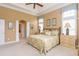 Serene main bedroom with soft lighting, floral bedding, and a connected private bathroom at 912 Berwick Ln., Myrtle Beach, SC 29579