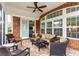 Relaxing screened patio with comfortable seating, a ceiling fan, and a brick exterior at 912 Berwick Ln., Myrtle Beach, SC 29579