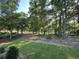 Large backyard with mature trees and lush green grass, offering a serene and private outdoor space at 924 Morrall Dr., North Myrtle Beach, SC 29582