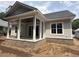 Back of home featuring a covered patio, white pillars, and gray siding at 924 Morrall Dr., North Myrtle Beach, SC 29582