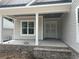 Inviting front porch featuring brick accents, stately columns, and double front doors at 924 Morrall Dr., North Myrtle Beach, SC 29582