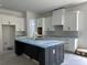 Kitchen featuring white cabinets, black island, modern fixtures and light countertops at 924 Morrall Dr., North Myrtle Beach, SC 29582