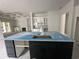 Kitchen with black island with sink and white cabinetry with glass doors at 924 Morrall Dr., North Myrtle Beach, SC 29582