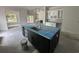Kitchen island featuring a sink and dark cabinets, complemented by white shaker cabinets at 924 Morrall Dr., North Myrtle Beach, SC 29582