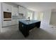 Bright kitchen showcasing a dark island, white cabinets, and modern appliances, creating a stylish culinary space at 924 Morrall Dr., North Myrtle Beach, SC 29582