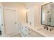 Bright bathroom featuring double sinks, modern fixtures, white cabinets, and a glass-enclosed shower at Simpson Creek Dr., Loris, SC 29569