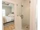 Modern bathroom featuring a glass shower with tiled walls and pebble floor with a view into the bedroom at Simpson Creek Dr., Loris, SC 29569