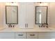 Modern bathroom with dual sinks, white cabinets, stylish mirrors, and elegant black fixtures at Simpson Creek Dr., Loris, SC 29569