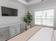 Bright bedroom with a television, large window, and wooden floors at Simpson Creek Dr., Loris, SC 29569