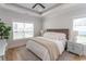 Inviting bedroom with large window, ceiling fan, wood flooring, and plush bedding at Simpson Creek Dr., Loris, SC 29569