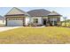 Charming single-story home featuring a manicured lawn and beautiful stone and siding exterior at Simpson Creek Dr., Loris, SC 29569