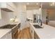 Bright kitchen boasts stainless steel appliances, white cabinetry, and quartz countertops at Simpson Creek Dr., Loris, SC 29569